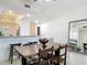 Cozy dining room with wooden table, chairs and granite kitchen in background at 265 Minorca Beach Way # 204, New Smyrna Beach, FL 32169