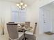 Dining area features neutral tones and a modern chandelier with natural light at 265 Minorca Beach Way # 204, New Smyrna Beach, FL 32169