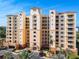 Front view of the condo building on a sunny day with lush landscaping at 265 Minorca Beach Way # 204, New Smyrna Beach, FL 32169