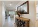 A lovely foyer leads into a bright living area, featuring a decorative table and a large mirror at 265 Minorca Beach Way # 204, New Smyrna Beach, FL 32169