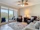 Bright living room with ceiling fan, outdoor patio, and comfortable furniture at 265 Minorca Beach Way # 204, New Smyrna Beach, FL 32169