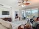 Comfortable living room with ceiling fan, TV and outdoor seating area at 265 Minorca Beach Way # 204, New Smyrna Beach, FL 32169