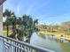 Beautiful pond view featuring palm trees and lush greenery, enhancing the tranquil setting at 265 Minorca Beach Way # 204, New Smyrna Beach, FL 32169