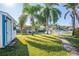 Landscaped backyard with palm trees and brick pathway at 275 Randle Ave, Oak Hill, FL 32759