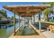 Covered boat lift with room for a small boat, benches, and a relaxing waterfront view at 275 Randle Ave, Oak Hill, FL 32759