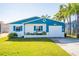 Charming beach cottage with blue accents and lush lawn at 275 Randle Ave, Oak Hill, FL 32759