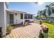 Brick paved patio with lush landscaping and white fence at 275 Randle Ave, Oak Hill, FL 32759