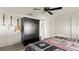 A bedroom with a ceiling fan, carpeted floors, and decorative guitars hanging on the wall at 2813 Sabal Palm Dr, Edgewater, FL 32141