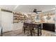 Well-lit kitchen featuring a center island with bar stool seating and floating shelves for decor and storage at 2813 Sabal Palm Dr, Edgewater, FL 32141