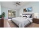 Nicely staged bedroom with sliding glass doors to balcony and ceiling fan at 2910 Oak Trail Run # 10, Port Orange, FL 32127