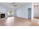 Spacious living room featuring fireplace, light-colored floors, and a sliding door to the balcony at 2910 Oak Trail Run # 10, Port Orange, FL 32127