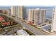 Aerial view showing oceanfront highrise condo building and coastal road at 2967 S Atlantic Ave # 801, Daytona Beach Shores, FL 32118