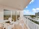 White chairs and table on balcony with city view at 2967 S Atlantic Ave # 801, Daytona Beach Shores, FL 32118