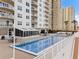 Inviting pool area with lounge chairs and patio tables at 2967 S Atlantic Ave # 801, Daytona Beach Shores, FL 32118