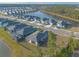 Aerial view of houses and a neighborhood near a lake at 3012 Portofino Blvd, New Smyrna Beach, FL 32168