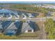 Aerial view of a house and neighborhood with a lake at 3012 Portofino Blvd, New Smyrna Beach, FL 32168