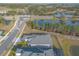 Aerial view of a house and neighborhood with a lake at 3012 Portofino Blvd, New Smyrna Beach, FL 32168