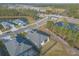 Aerial view of a house and neighborhood with a lake at 3012 Portofino Blvd, New Smyrna Beach, FL 32168