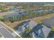 Aerial view of a house and neighborhood with a lake at 3012 Portofino Blvd, New Smyrna Beach, FL 32168