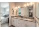 Bathroom with double vanity, granite countertop, and a view of bedroom at 3012 Portofino Blvd, New Smyrna Beach, FL 32168