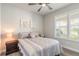 Comfortable bedroom with a queen bed and ceiling fan at 3012 Portofino Blvd, New Smyrna Beach, FL 32168