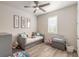 Bright bedroom with daybed, window seat, and wood-look floors at 3012 Portofino Blvd, New Smyrna Beach, FL 32168