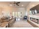 Relaxing living room featuring a fireplace, large TV, and comfortable seating at 3012 Portofino Blvd, New Smyrna Beach, FL 32168