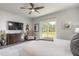 Main bedroom with sliding glass doors to backyard, dresser and ceiling fan at 3012 Portofino Blvd, New Smyrna Beach, FL 32168