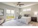 Spacious main bedroom with lake view, ceiling fan, and ample natural light at 3012 Portofino Blvd, New Smyrna Beach, FL 32168