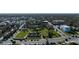 Scenic aerial view capturing the city, historical ruins, lush park, and the serene waterfront at 314 Hillman St, New Smyrna Beach, FL 32168
