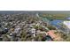 Aerial view of neighborhood with houses, trees, and a river, showcasing the property's location at 314 Hillman St, New Smyrna Beach, FL 32168
