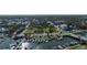 Aerial view of city with park, river with boats, and a mix of residential and commercial buildings at 314 Hillman St, New Smyrna Beach, FL 32168