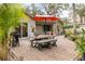 Relaxing back patio with a grill and ample outdoor seating, ideal for entertaining guests at 314 Hillman St, New Smyrna Beach, FL 32168