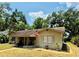 Well-kept ranch style home featuring an American flag and mature landscaping at 314 Hillman St, New Smyrna Beach, FL 32168