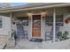 Charming covered front porch with decorative lighting and inviting seating area at 314 Hillman St, New Smyrna Beach, FL 32168