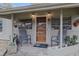 Inviting front porch with seating area and decorative plants creating a cozy entrance at 314 Hillman St, New Smyrna Beach, FL 32168