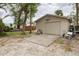 A detached garage with a basketball hoop in a grassy backyard at 314 Hillman St, New Smyrna Beach, FL 32168