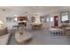 Bright living room featuring neutral decor, open layout, and seamless flow into the dining area and kitchen at 314 Hillman St, New Smyrna Beach, FL 32168