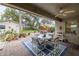 Outdoor patio with comfortable seating, overlooking a lush backyard with mature trees and landscaping at 314 Hillman St, New Smyrna Beach, FL 32168