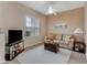 Cozy living room with a comfortable sofa, ottoman, and large window at 323 Mariners Gate Dr, Edgewater, FL 32141