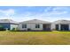 View of backyard, screened patio, and neighboring houses at 3257 Carpentaria Dr, New Smyrna Beach, FL 32168