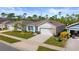 Single story home with a two car garage, and teal shutters at 3257 Carpentaria Dr, New Smyrna Beach, FL 32168