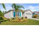 Single story house with teal accents and palm tree at 3257 Carpentaria Dr, New Smyrna Beach, FL 32168