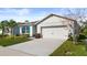 Front view of a single story house with a two car garage at 3257 Carpentaria Dr, New Smyrna Beach, FL 32168