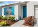 Teal front door and landscaping at 3257 Carpentaria Dr, New Smyrna Beach, FL 32168