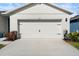 Two-car garage with light beige door at 3257 Carpentaria Dr, New Smyrna Beach, FL 32168