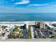 Aerial view of beach front property featuring ocean views, parking, and sandy beach at 3405 S Atlantic Ave # 501, New Smyrna Beach, FL 32169