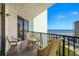 Ocean view balcony with outdoor seating, including chairs and a glass-topped table at 3405 S Atlantic Ave # 501, New Smyrna Beach, FL 32169