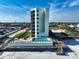 An eye-level exterior view of a high-rise building with a private outdoor swimming pool and lounge area at 3405 S Atlantic Ave # 501, New Smyrna Beach, FL 32169