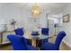 Inviting dining space featuring modern blue chairs, a glass table and bright lighting at 3405 S Atlantic Ave # 501, New Smyrna Beach, FL 32169